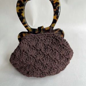 Brown woven and tortoise top handle bag